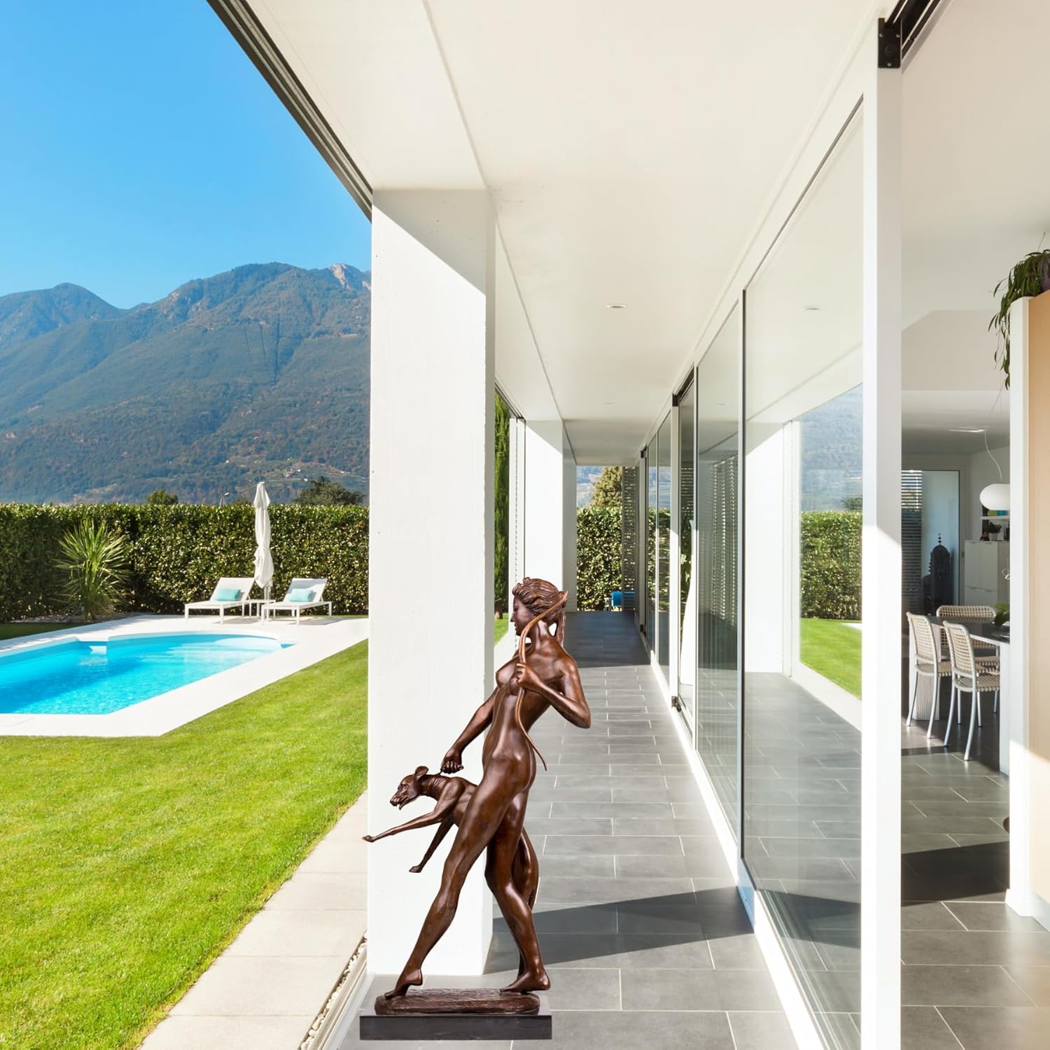Side view of large bronze Artemis huntress sculpture in garden outdoor display