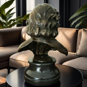 Bronze Chopin bust statue displayed alongside gold decorative vase in indoor setting