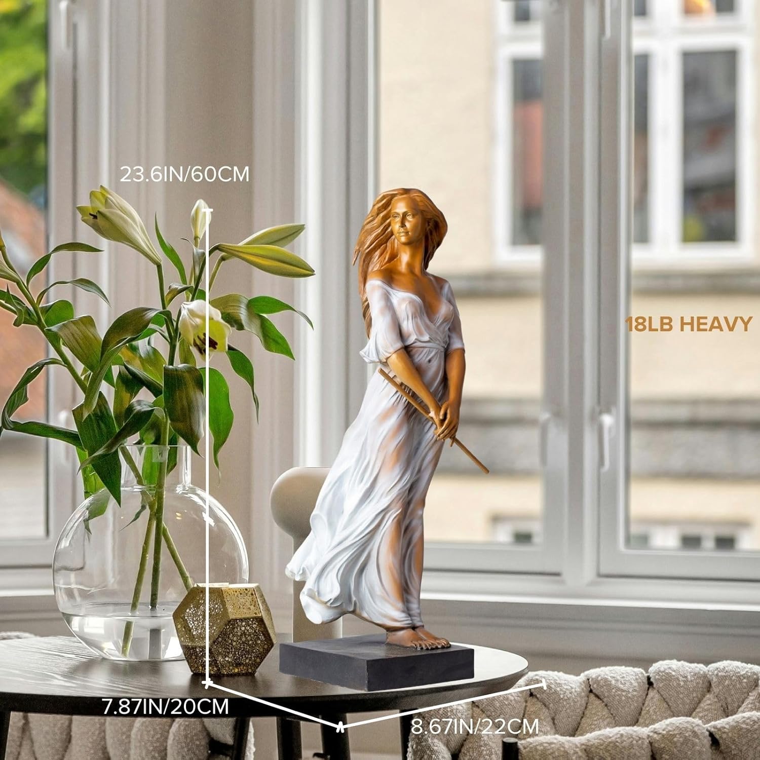 Bronze elegant woman with flute statue on interior side table with green plants