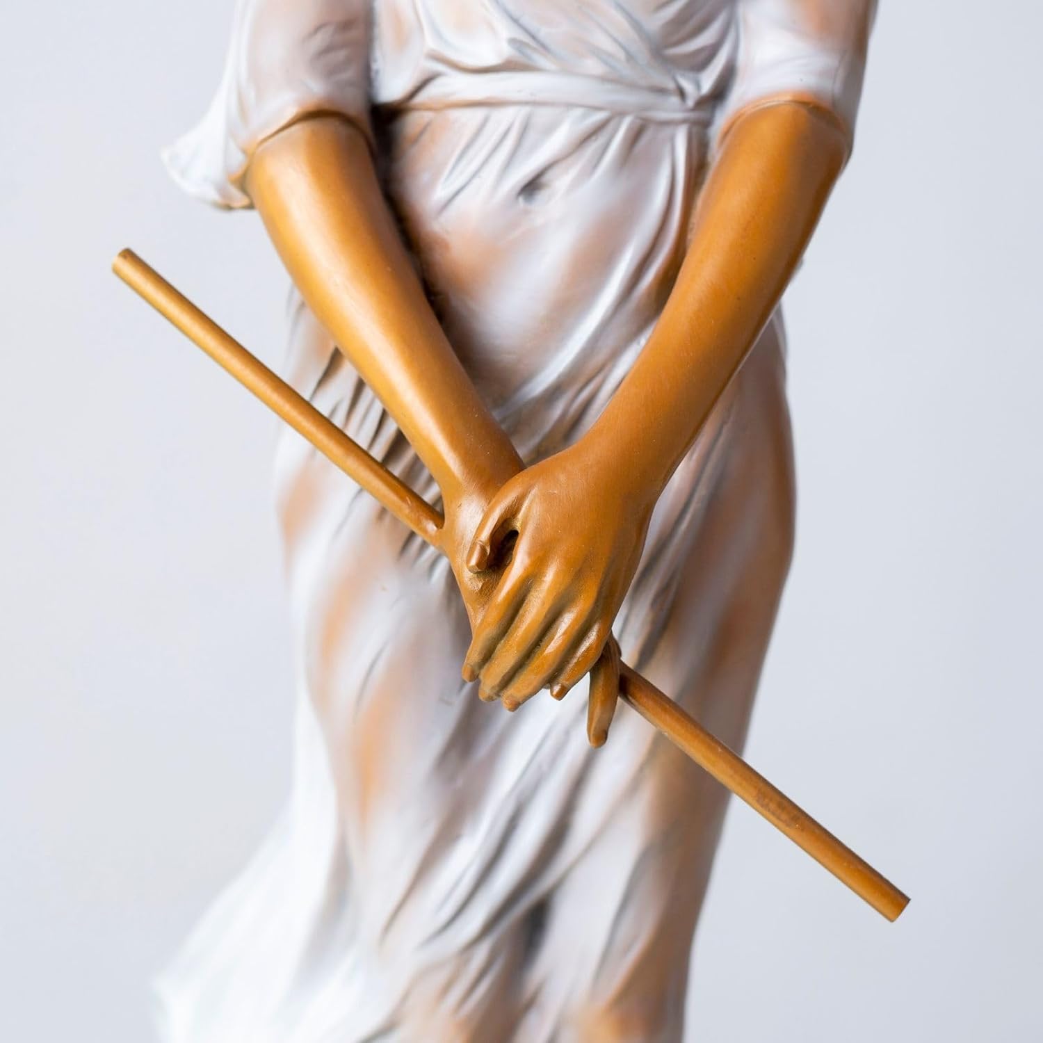 Bronze elegant woman with flute statue bronze label detail beside window natural light