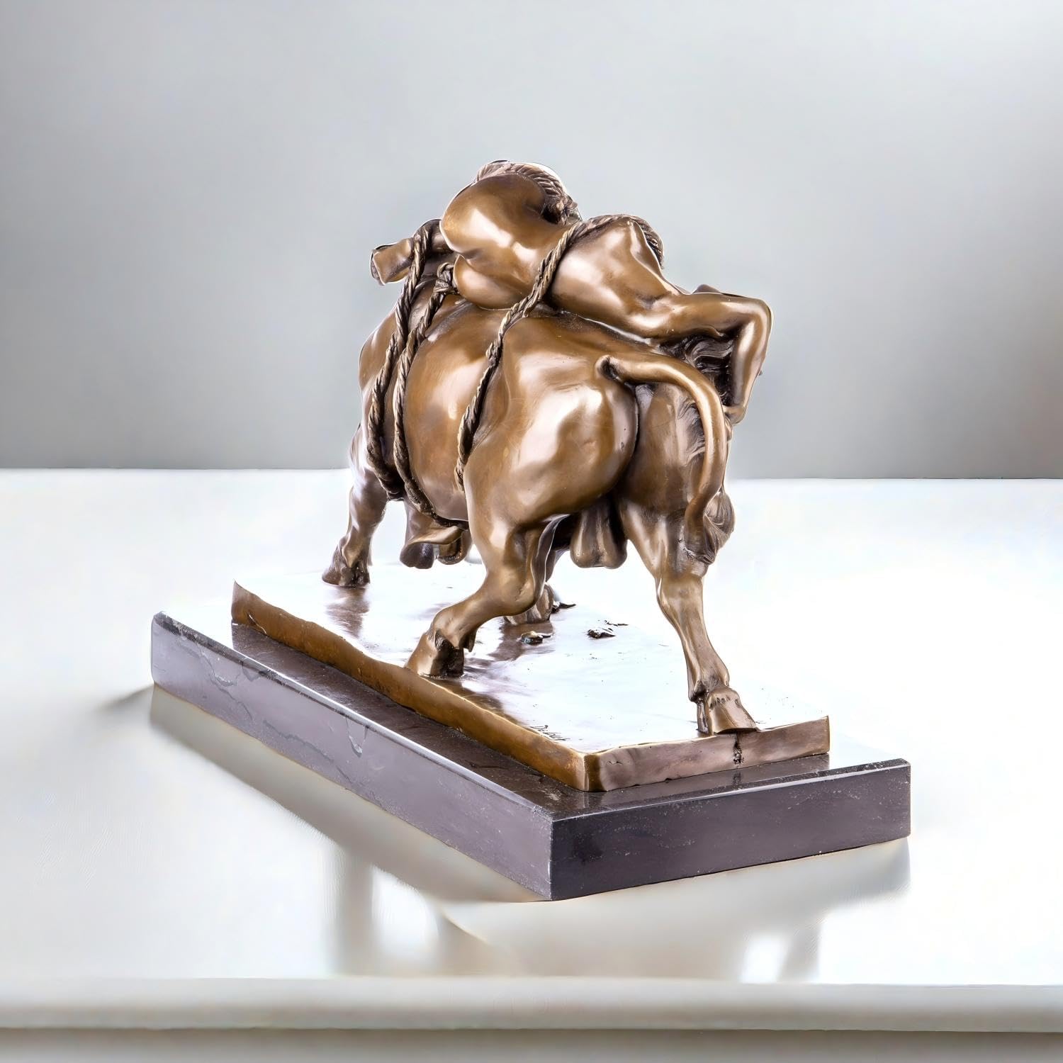 Bronze Europa and the Bull Zeus sculpture displayed at angle on indoor wooden table setting