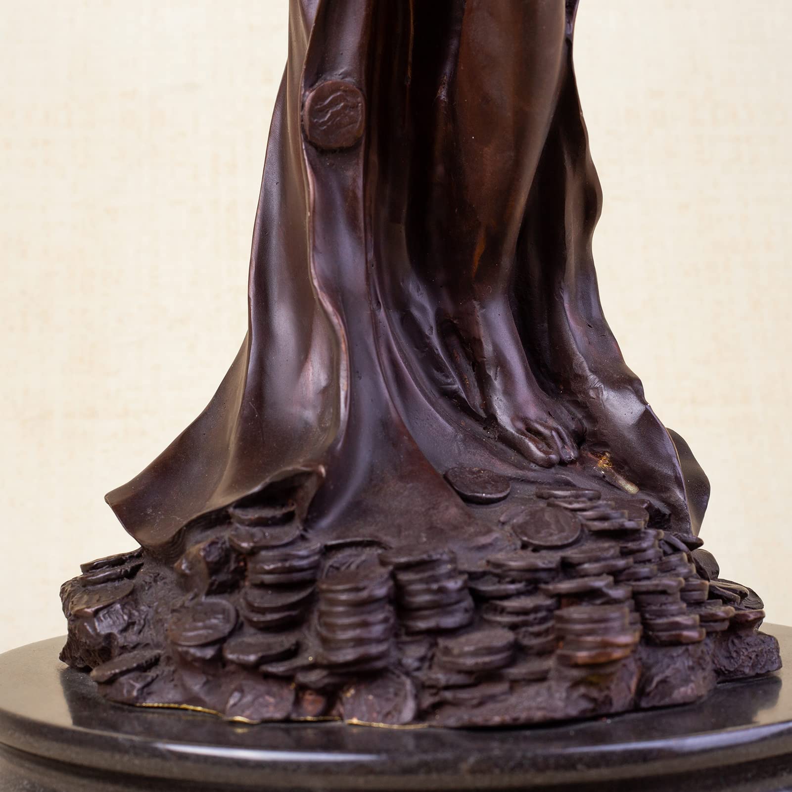 Bronze Fortuna goddess wealth statue base coins and lotus detail close up