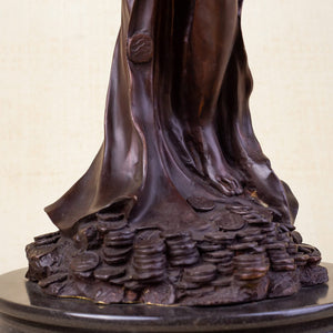 Bronze Fortuna goddess wealth statue base coins and lotus detail close up