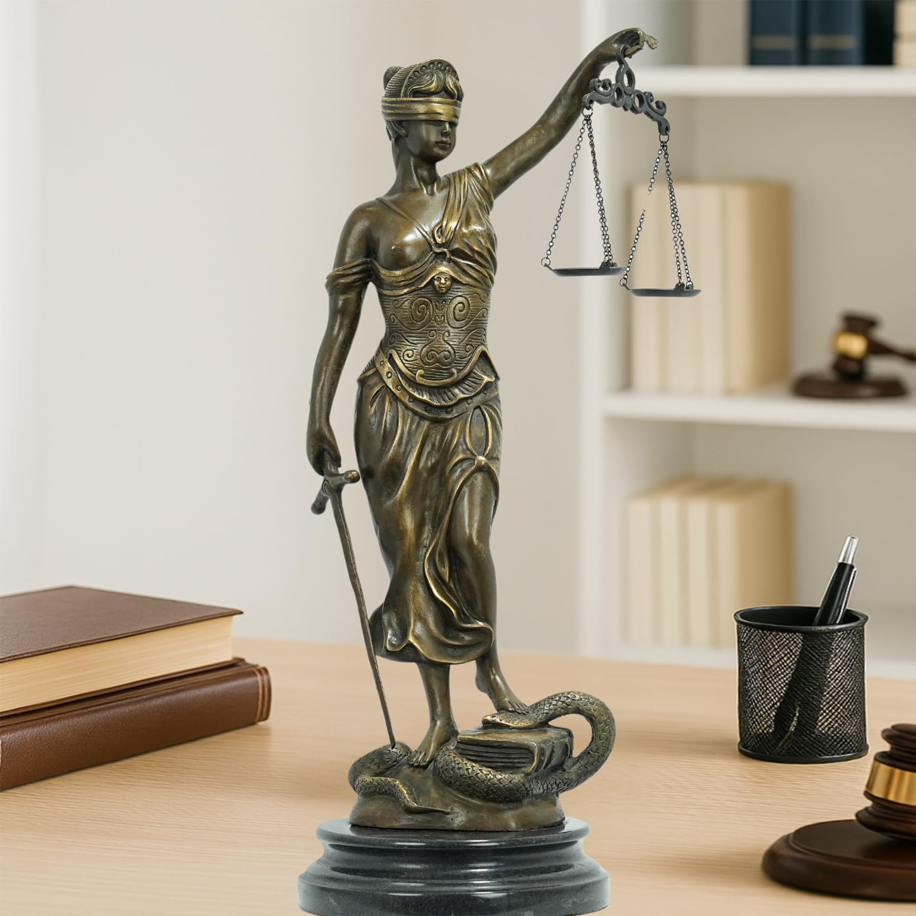 Bronze Lady Justice Themis statue displayed on modern office desk with laptop in professional setting
