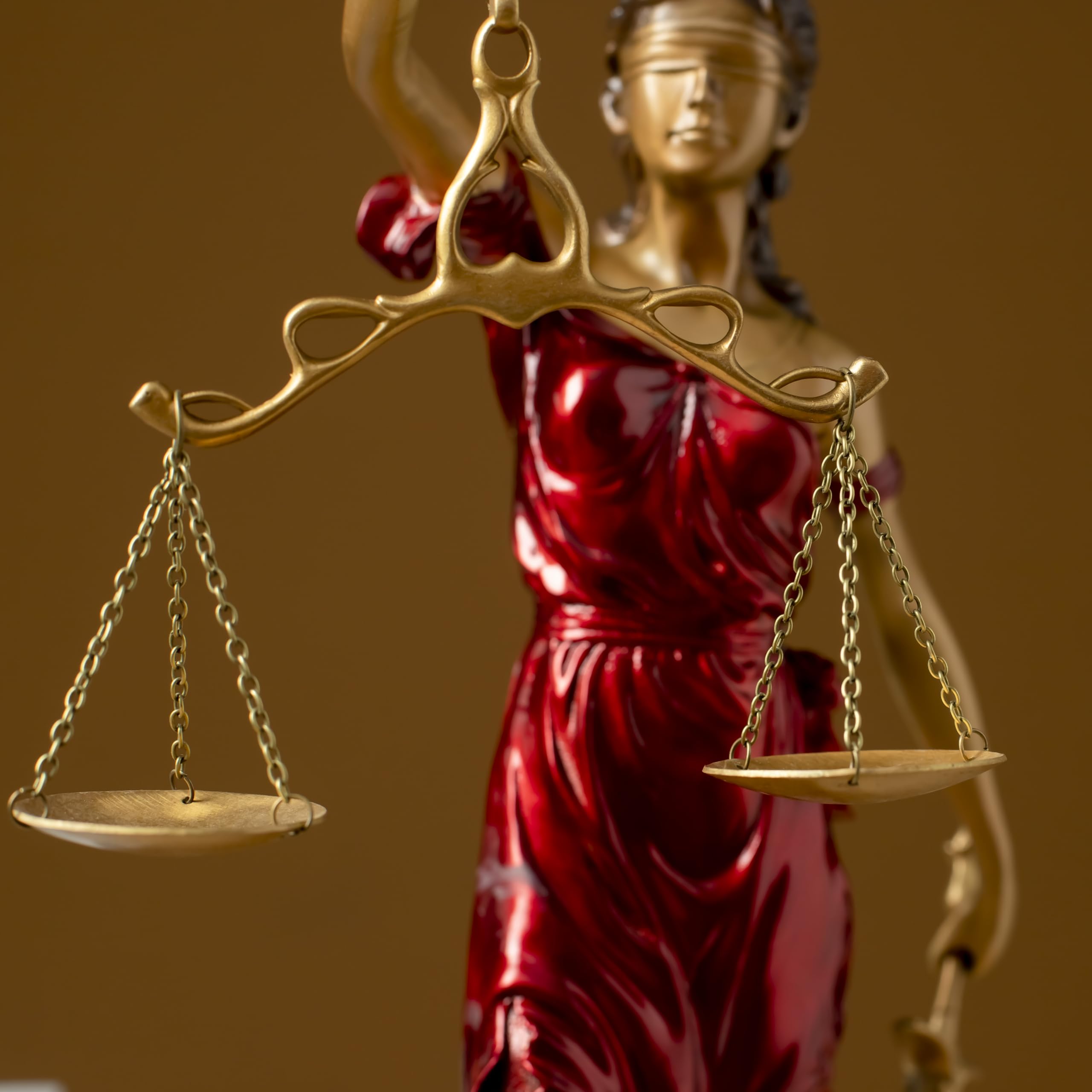 Bronze Lady Justice Themis statue in law office with male attorney handshake symbolizing justice