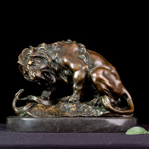 Front angle of dark bronze lion and serpent Barye sculpture on marble base against black background
