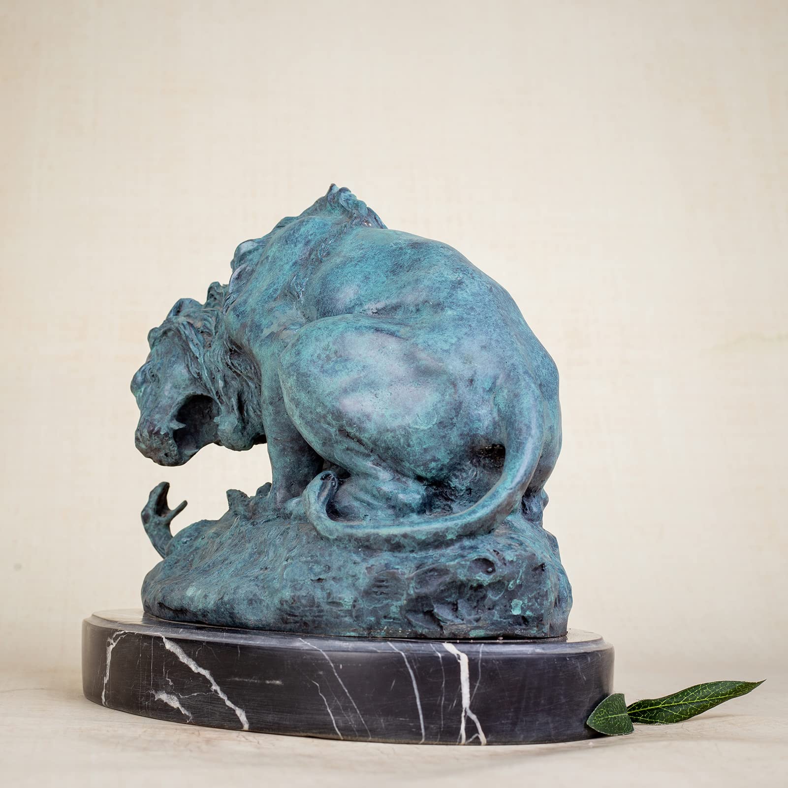 Dark bronze patina lion and serpent sculpture after Barye on marble base, side view beige background
