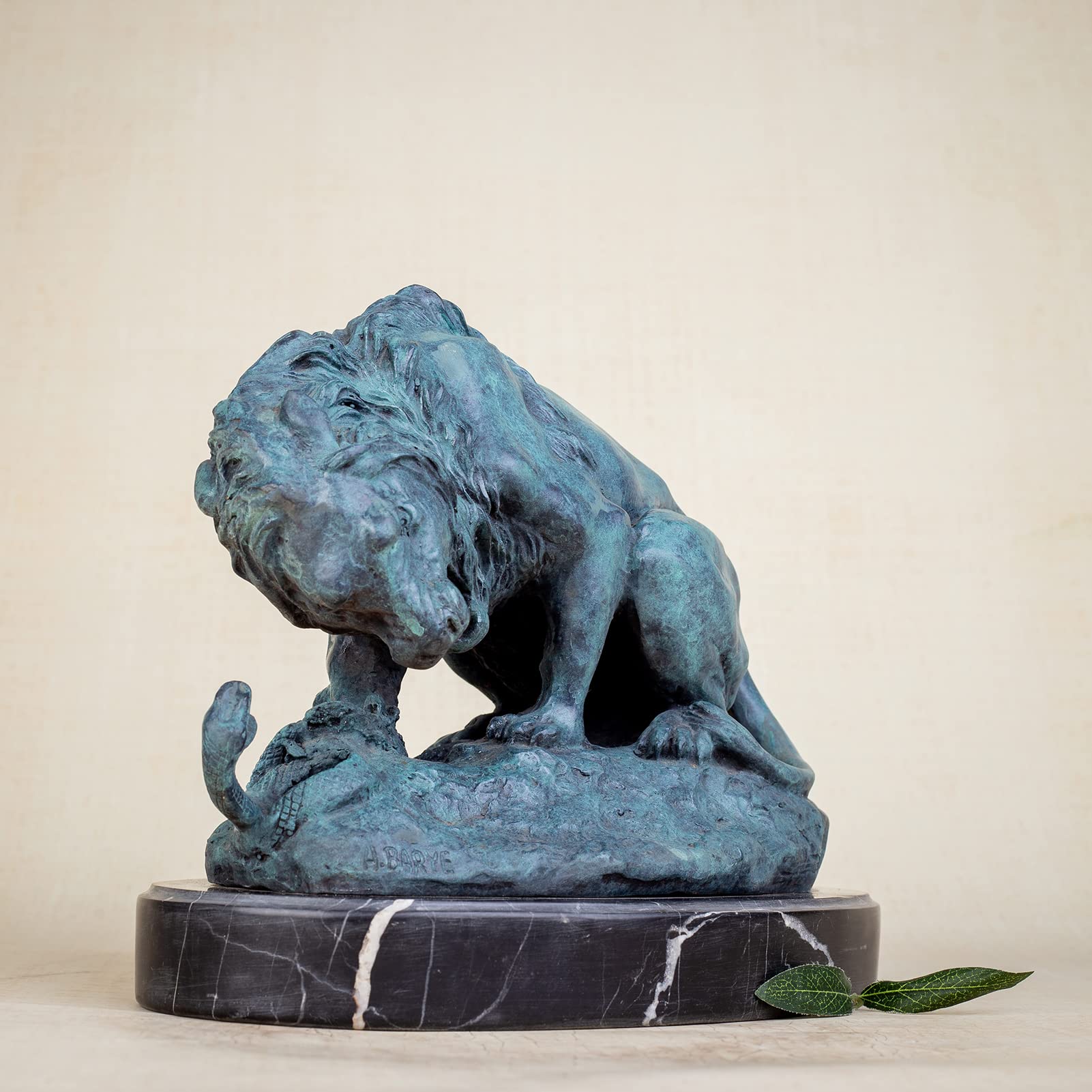 Front view of teal patina bronze lion and serpent sculpture after A. Barye on marble base