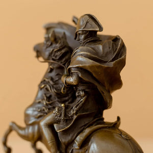 Close-up front detail of bronze Napoleon statue showing flowing cape and rider head on rearing horse