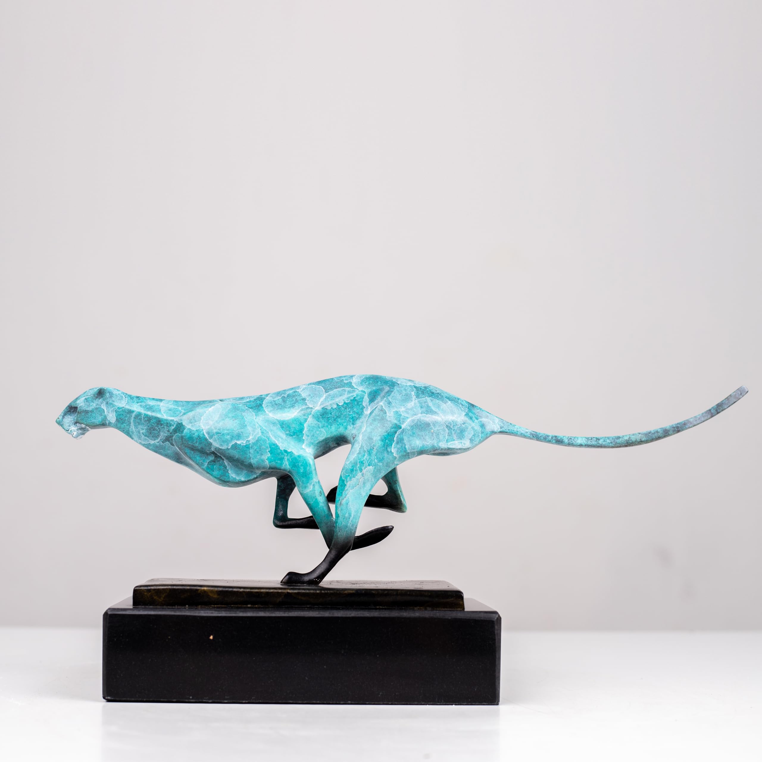 Teal azure running cheetah sculpture on black marble base side view display