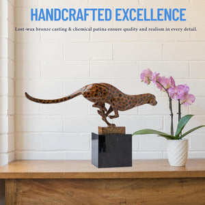 Close-up side view of bronze running cheetah statue in dynamic leaping pose on marble base