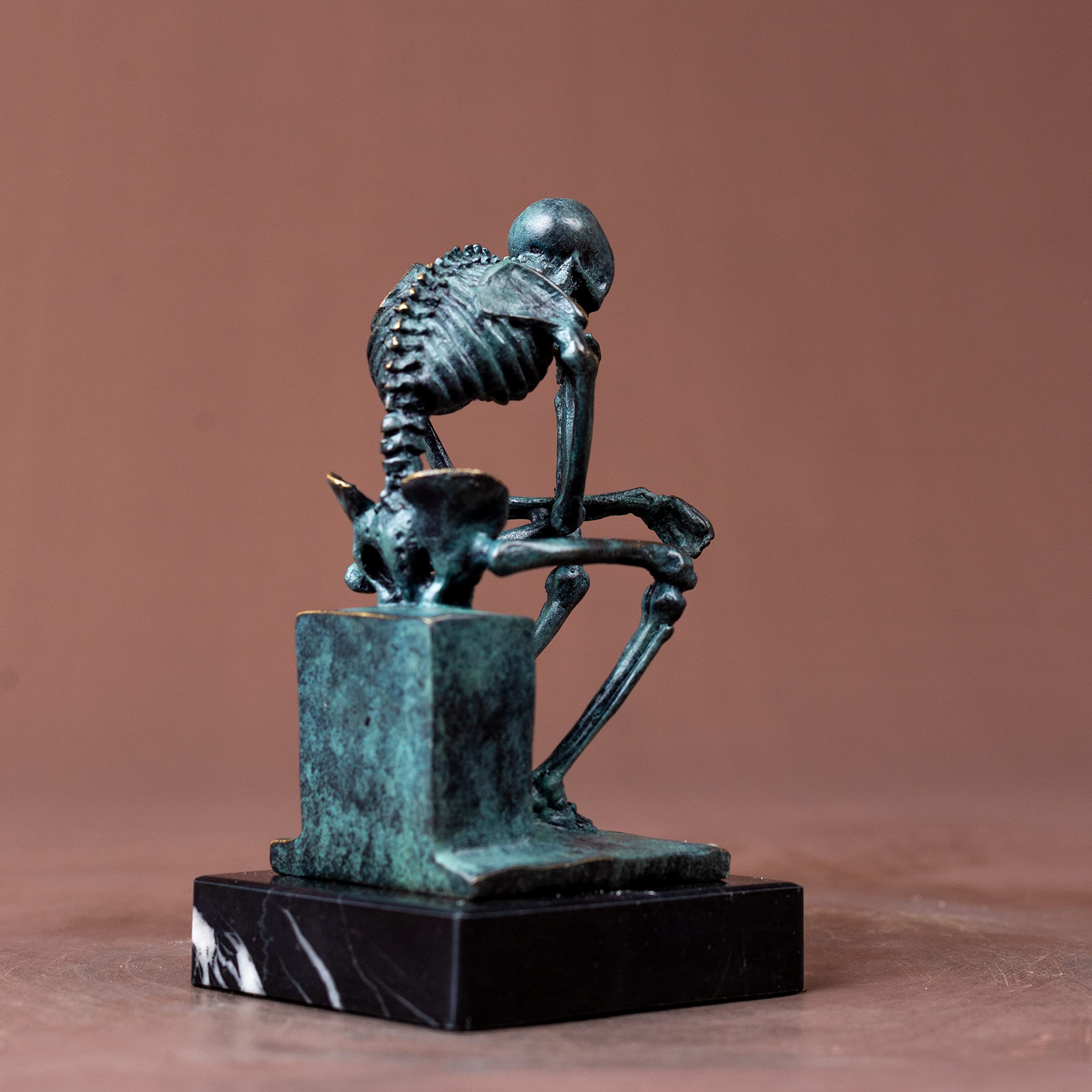 Bronze skeleton Thinker statue in blue-grey finish dimensions reference card showing height and width