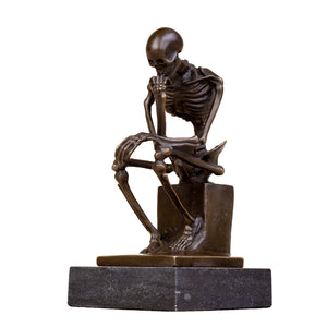 Bronze skeleton Thinker statue in blue-grey patina front view on light background