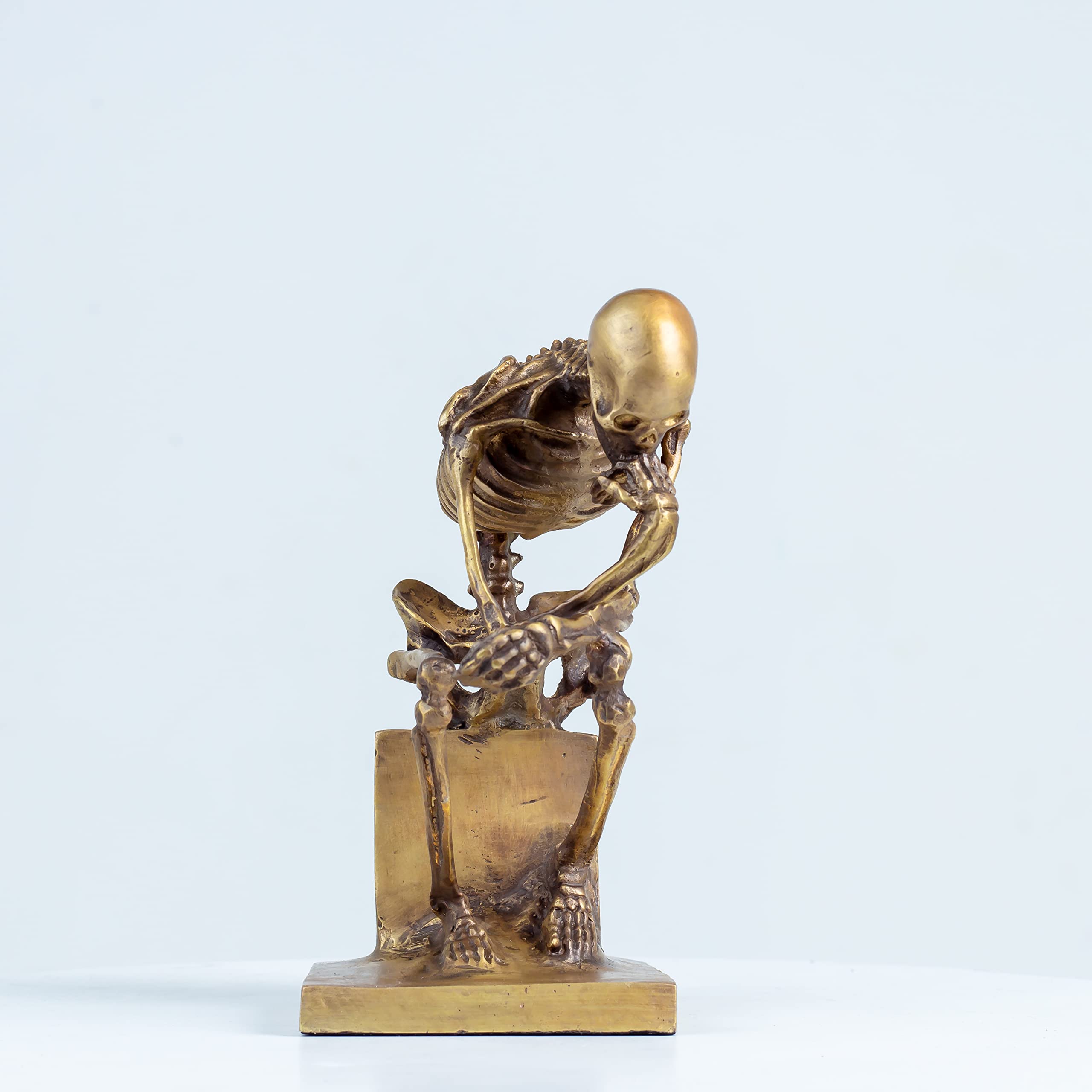 Bronze skeleton Thinker statue in gold finish side angle view showing seated skeletal pose