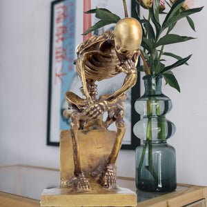 Bronze skeleton Thinker statue in gold finish side view showing detailed skeletal sculpting