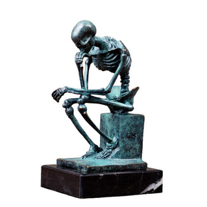 Bronze skeleton Thinker statue in green patina finish front view on white background