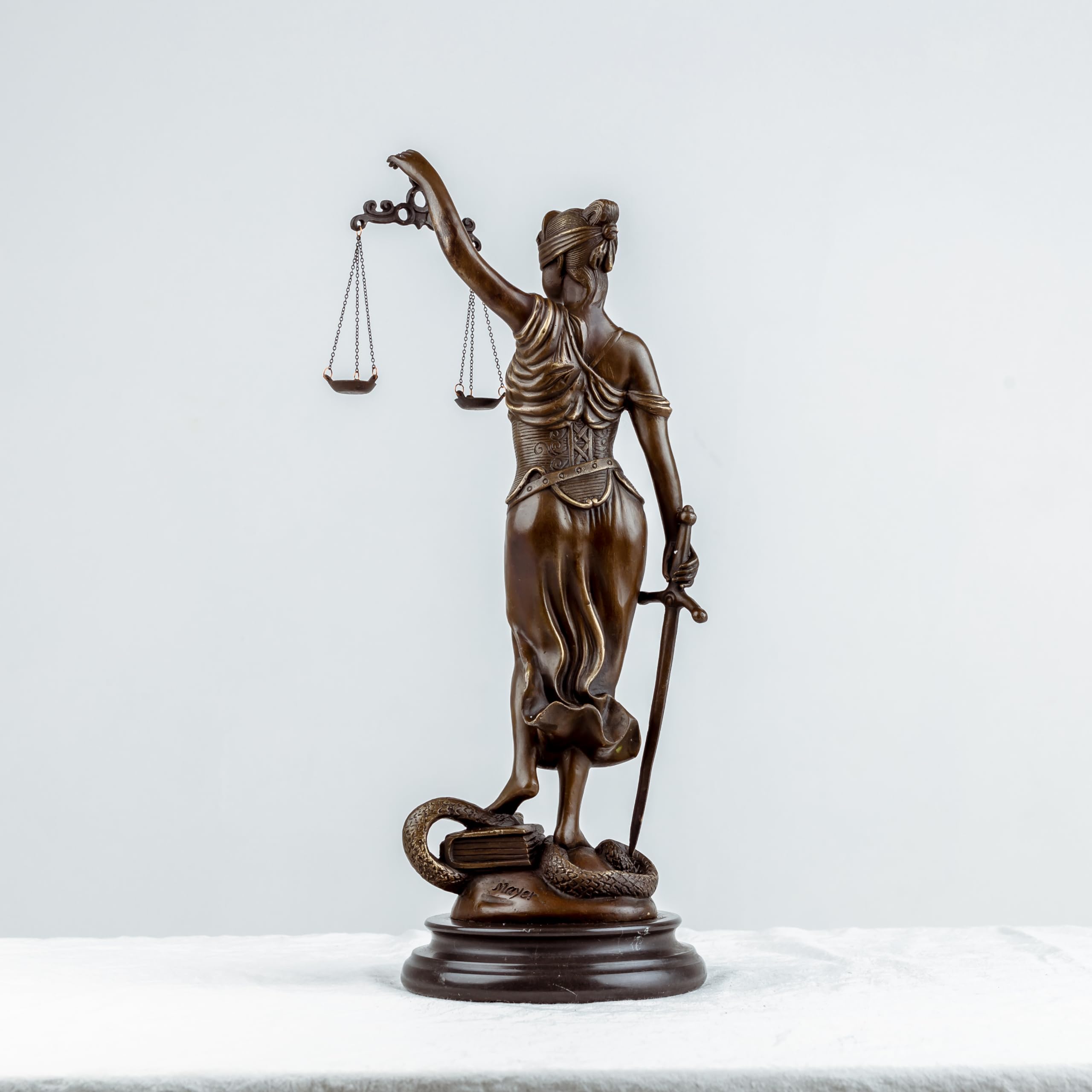 Bronze Themis Lady Justice statue side full body view on white background showing flowing robe detail
