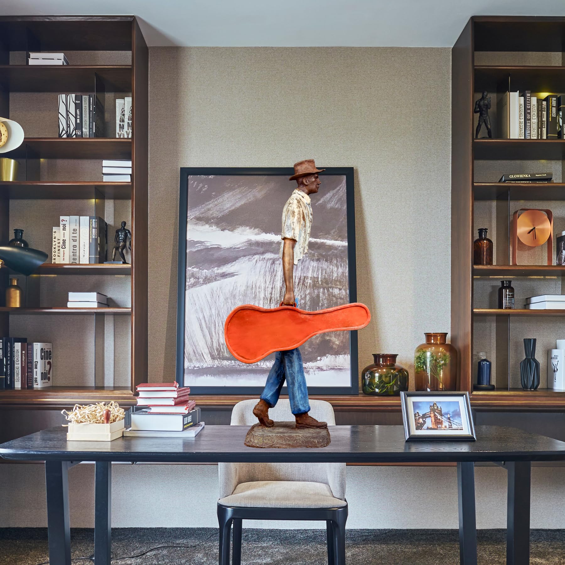 Close-up of the detailed facial features and classic hat on the bronze musician sculpture.