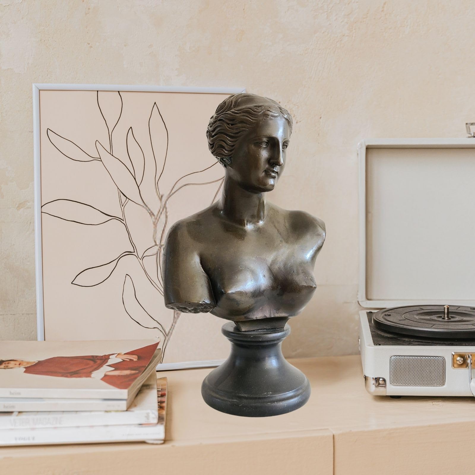 Bronze Venus de Milo bust statue displayed indoors with photo frame in lifestyle setting