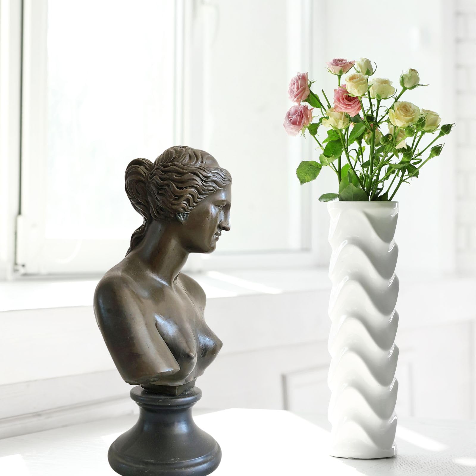 Bronze Venus de Milo bust statue displayed in modern living room alongside decorative vase