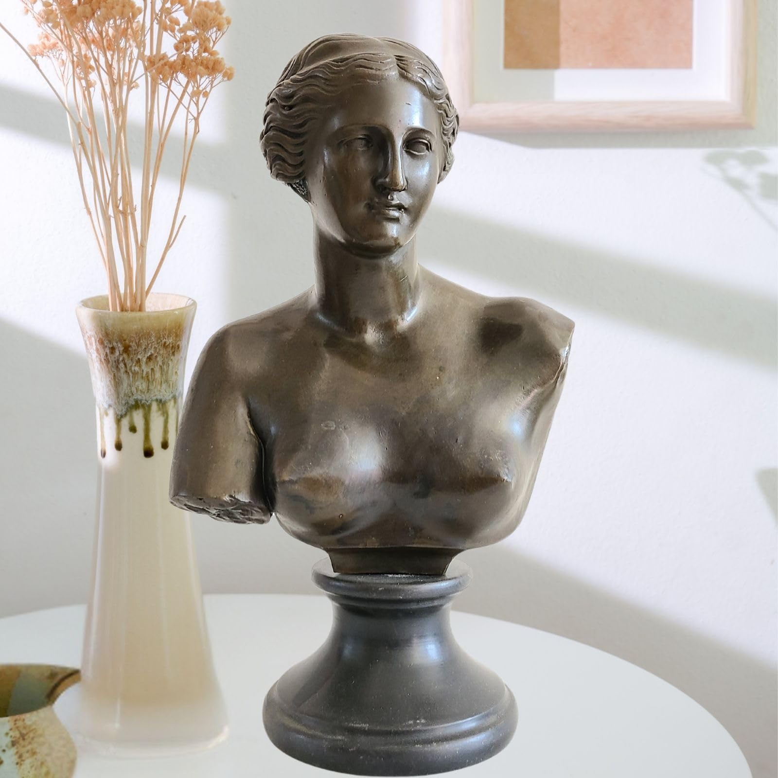 Bronze Venus de Milo bust statue Greek goddess of love and beauty on marble base, displayed on white console table