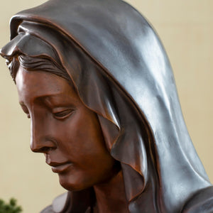Close-up angle detail of bronze Virgin Mary bust statue showing intricate veil and headpiece texture