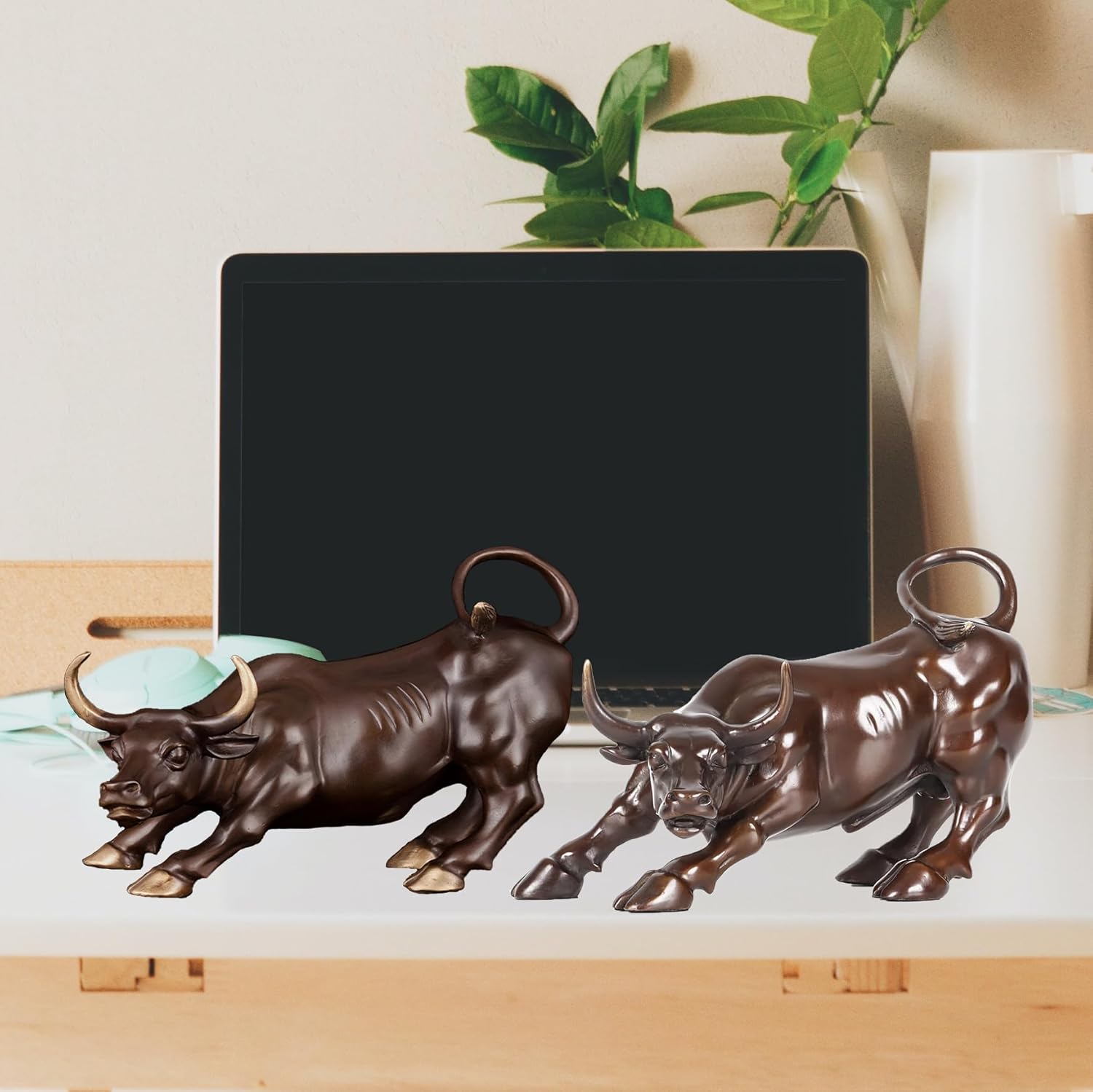 View of the solid brass base of the brown bull with gold hooves.
