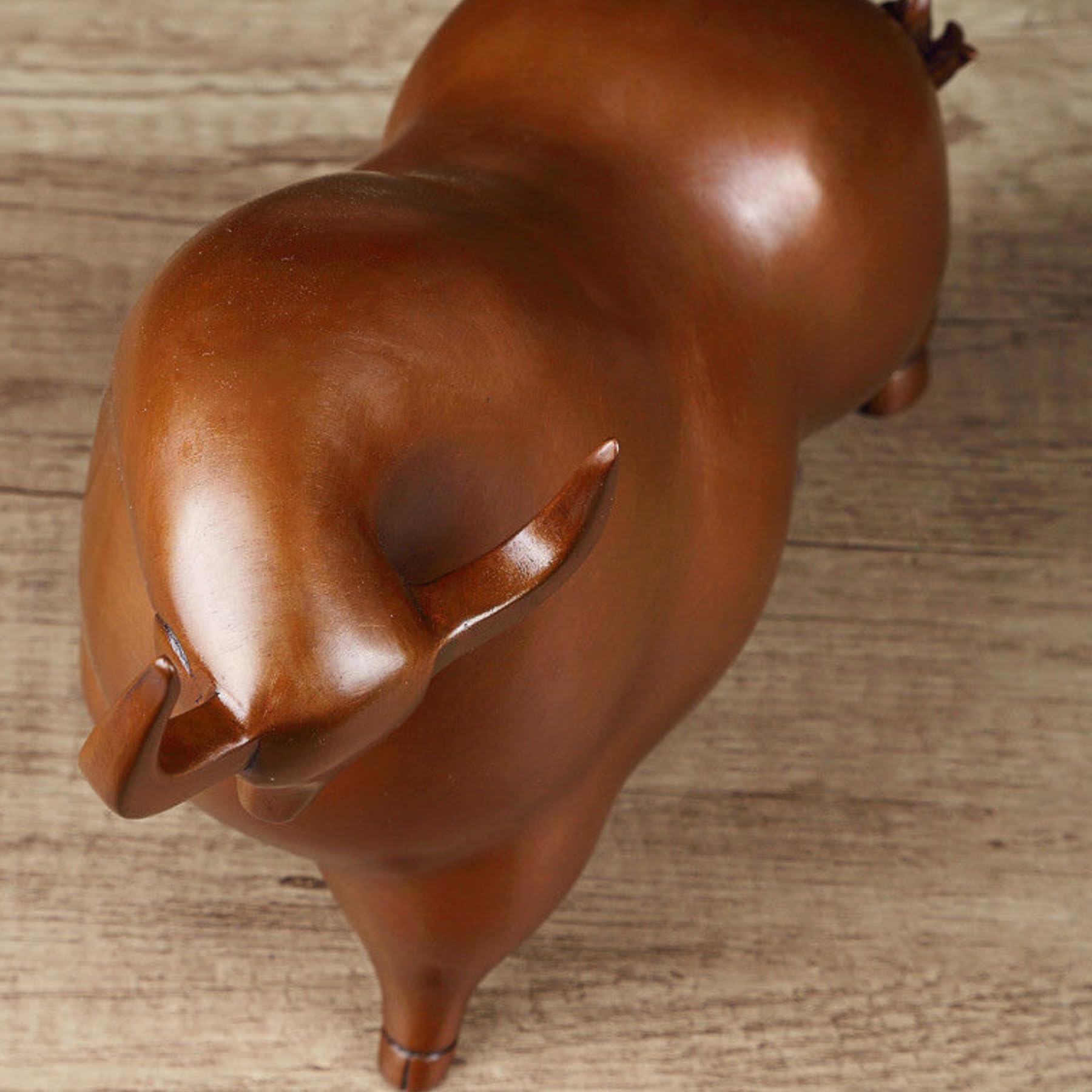Brown bronze bull statue styled on a professional executive desk.
