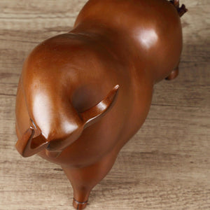 Brown bronze bull statue styled on a professional executive desk.