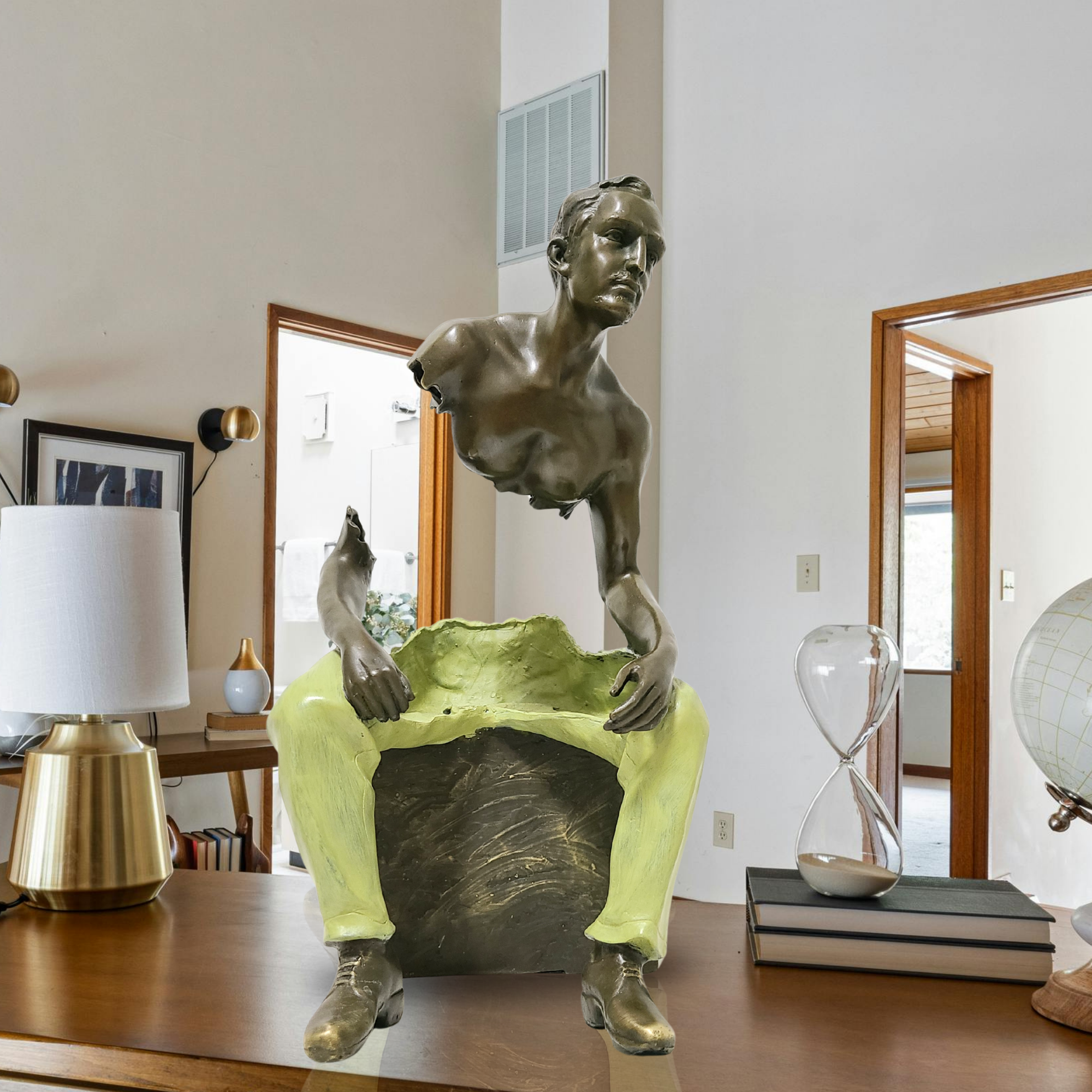 Bruno Catalano inspired seated fragmented bronze traveler sculpture in modern home interior