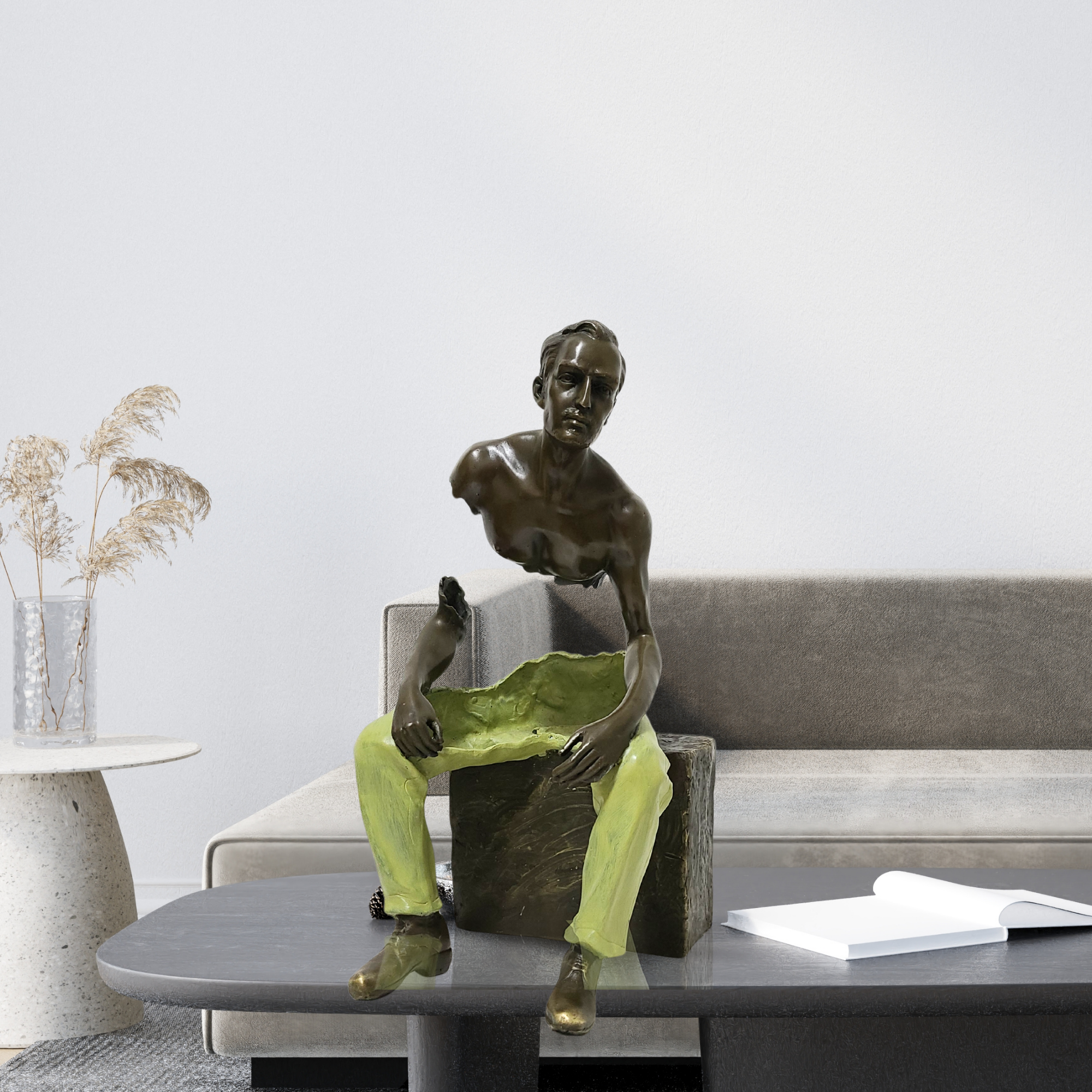 Bruno Catalano Les Voyageurs seated bronze fragmented sculpture displayed on living room sofa