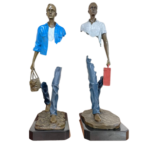 Two large 63cm Bruno Catalano inspired bronze traveler statues in Midnight Navy and Greyish White with marble bases.