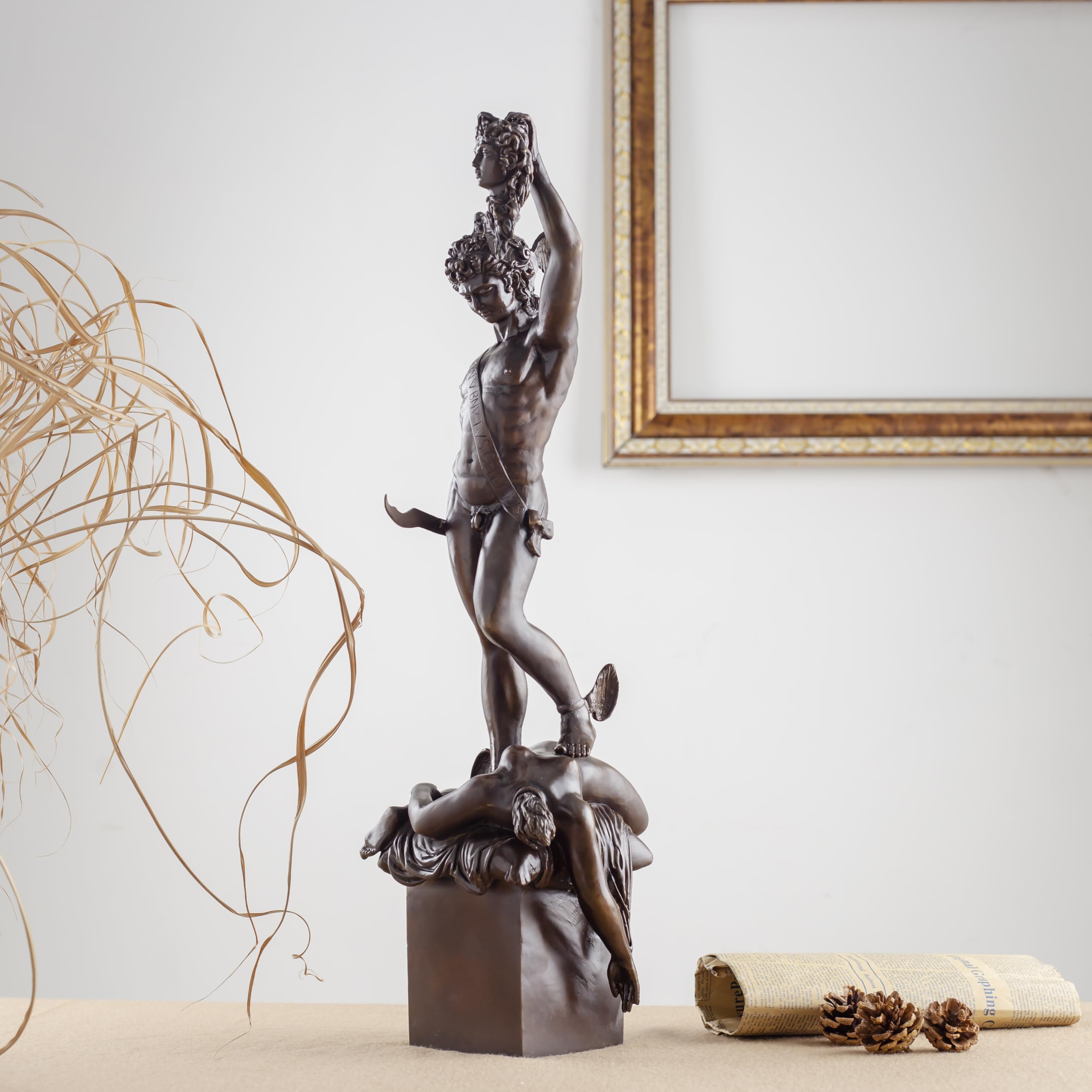 Cellini Perseus Medusa green bronze sculpture displayed beside fireplace in luxury interior