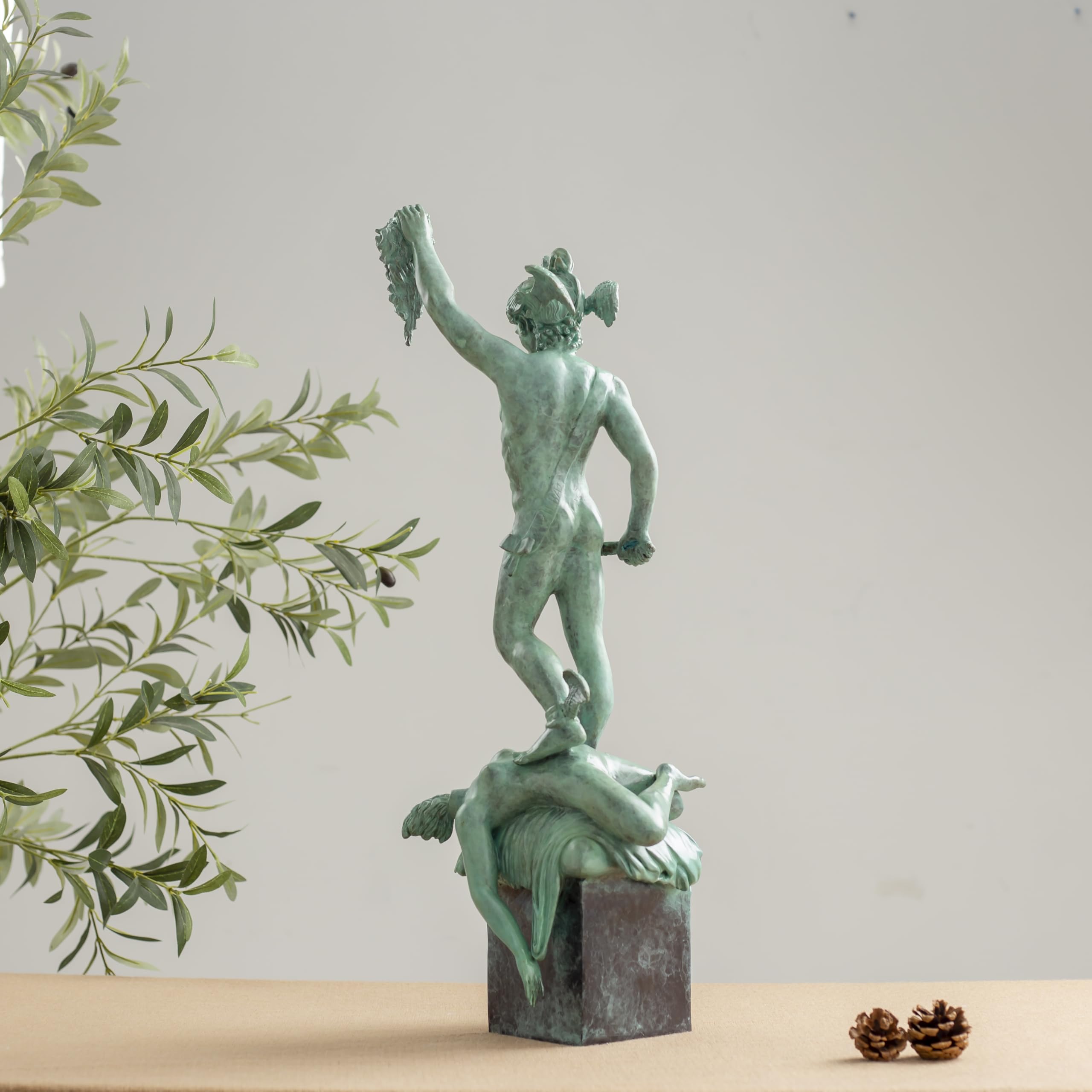 Right angle view of Perseus Medusa green bronze sculpture showing figure detail