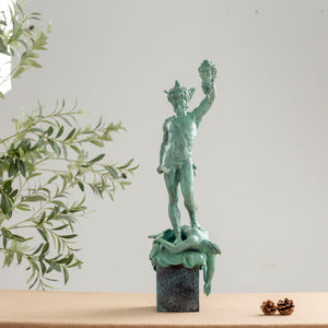 Side view of Cellini Perseus Medusa green bronze sculpture on decorative base