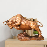 Golden yellow Wall Street charging bull statue, front view.