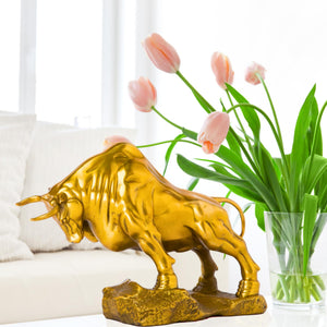 Golden yellow charging bull sculpture, side profile display