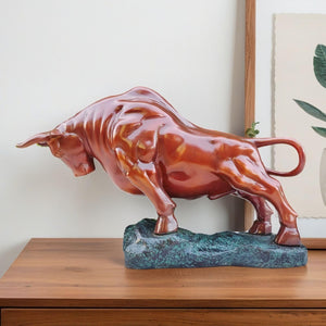 Orange-red Wall Street charging bull statue, front view.