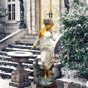 Chione goddess bronze statue displayed on stone steps outside European style building as garden sculpture