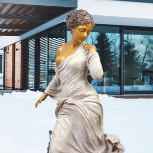 Chione winter goddess bronze statue placed outdoors in snow scene beside European architecture