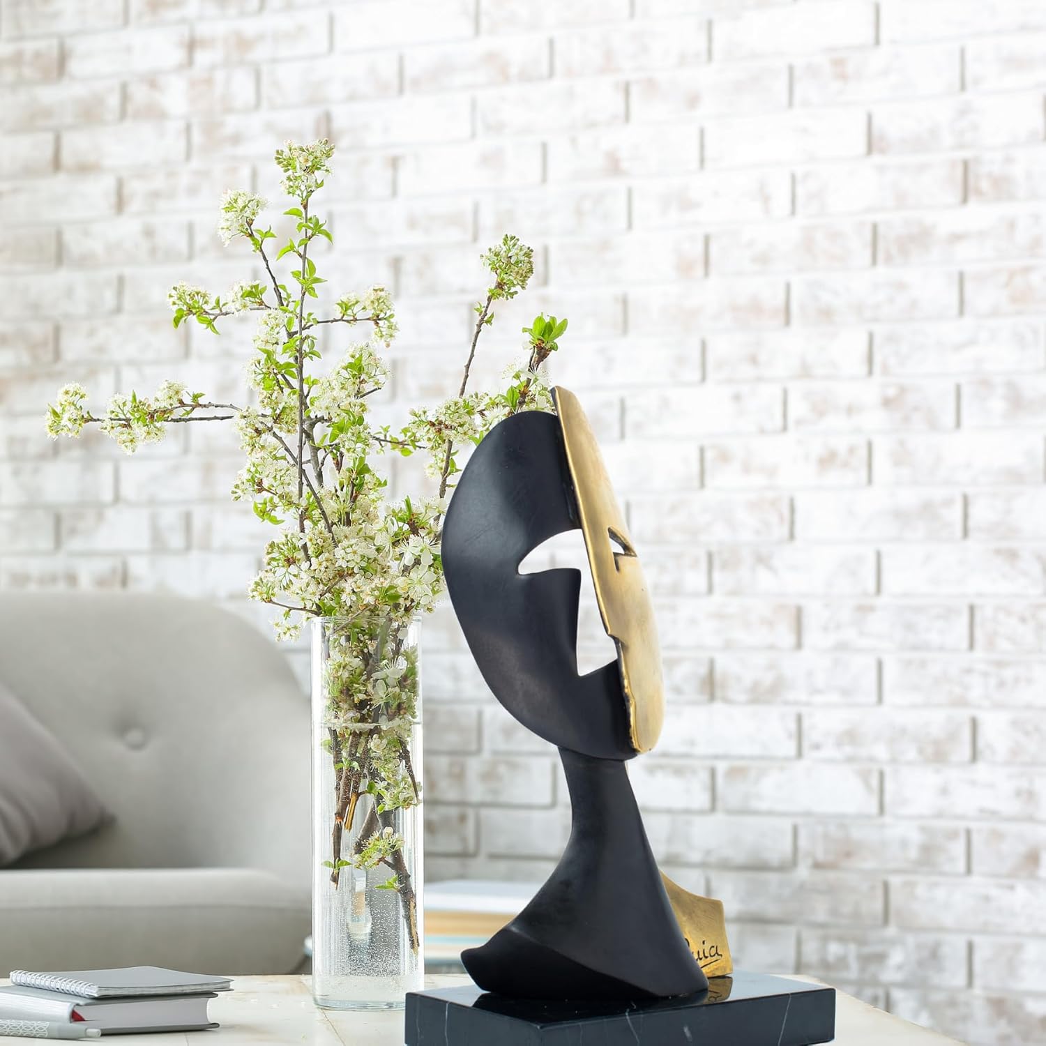 Cubist mask bronze sculpture in modern living room with sofa background as contemporary home decor