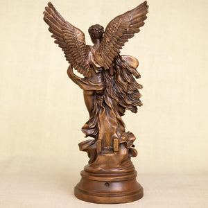 Cupid Psyche bronze sculpture displayed in office beside wall art ampersand decor