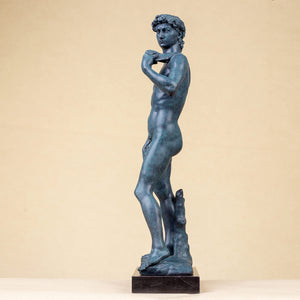 David modern bronze statue three-quarter angle view on beige background showing body and base detail