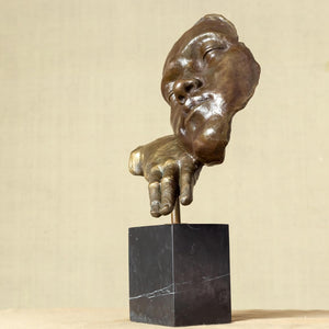 Right angle view of Deep Reflection abstract bronze thinker hand and face sculpture