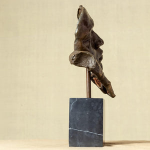 Side profile of Deep Reflection bronze meditator sculpture showing hand cradling face