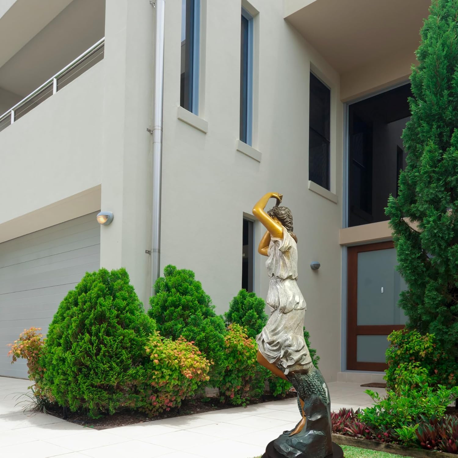 Demeter harvest goddess bronze statue beside garden hedge as outdoor mythology sculpture display
