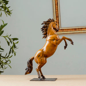 Gold bronze rearing stallion desk edition sculpture side view with greenery and framed art