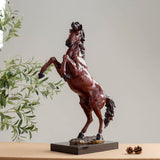 28.3-inch red bronze elite rearing stallion sculpture on marble base displayed indoors with greenery decor
