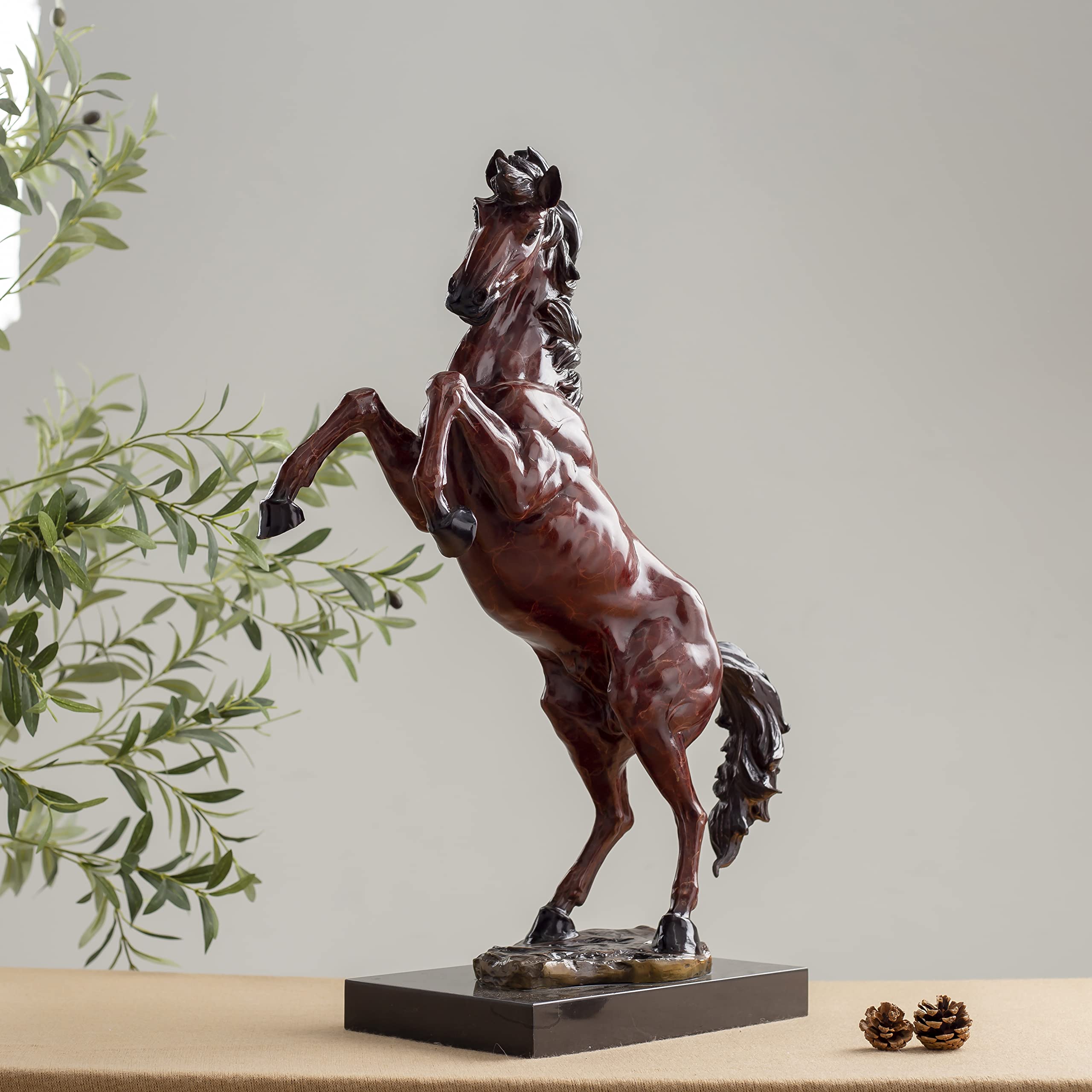 28.3-inch red bronze elite rearing stallion sculpture on marble base displayed indoors with greenery decor