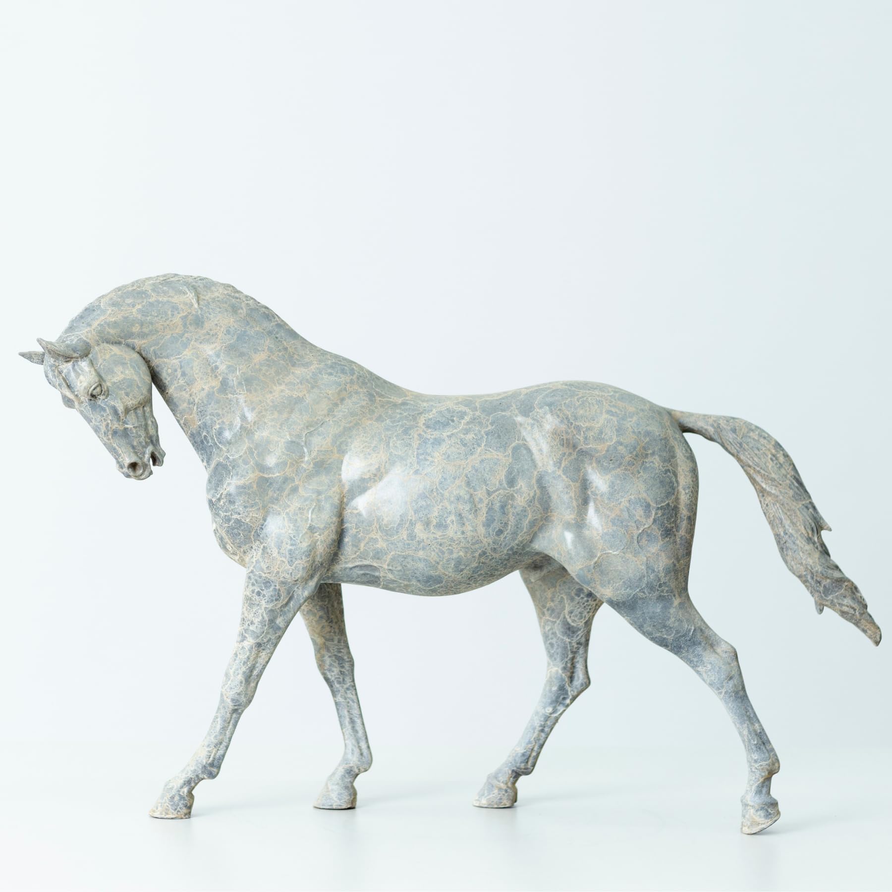European Andalusian horse bronze sculpture in white finish, walking stallion side view on white background